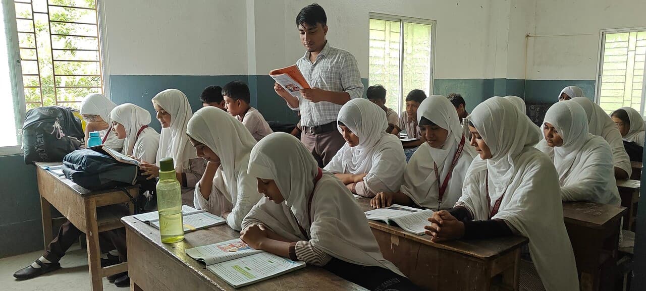 A teacher reading to students in a classroom