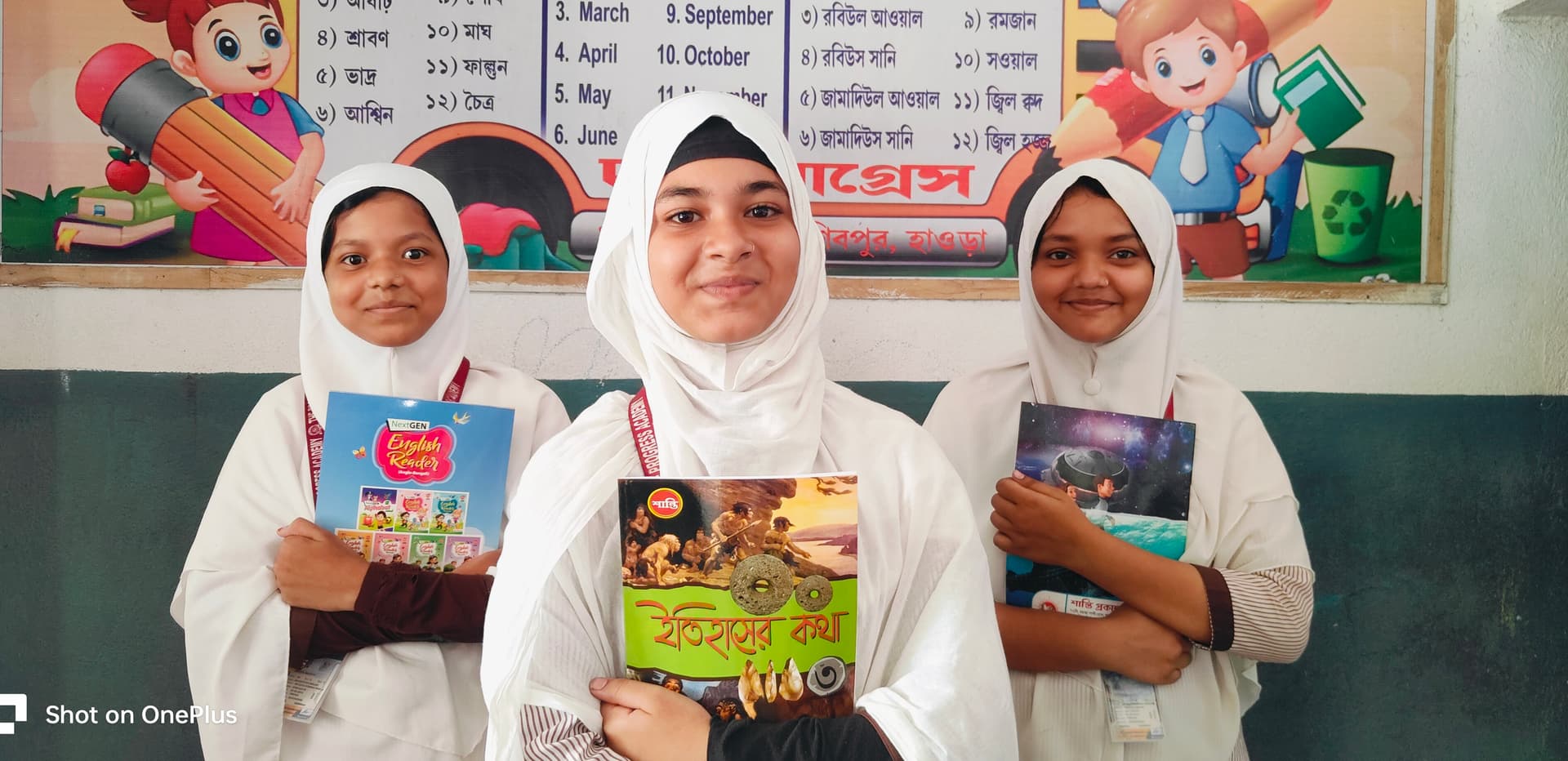 Three students of The Progress Academy holding their textbooks