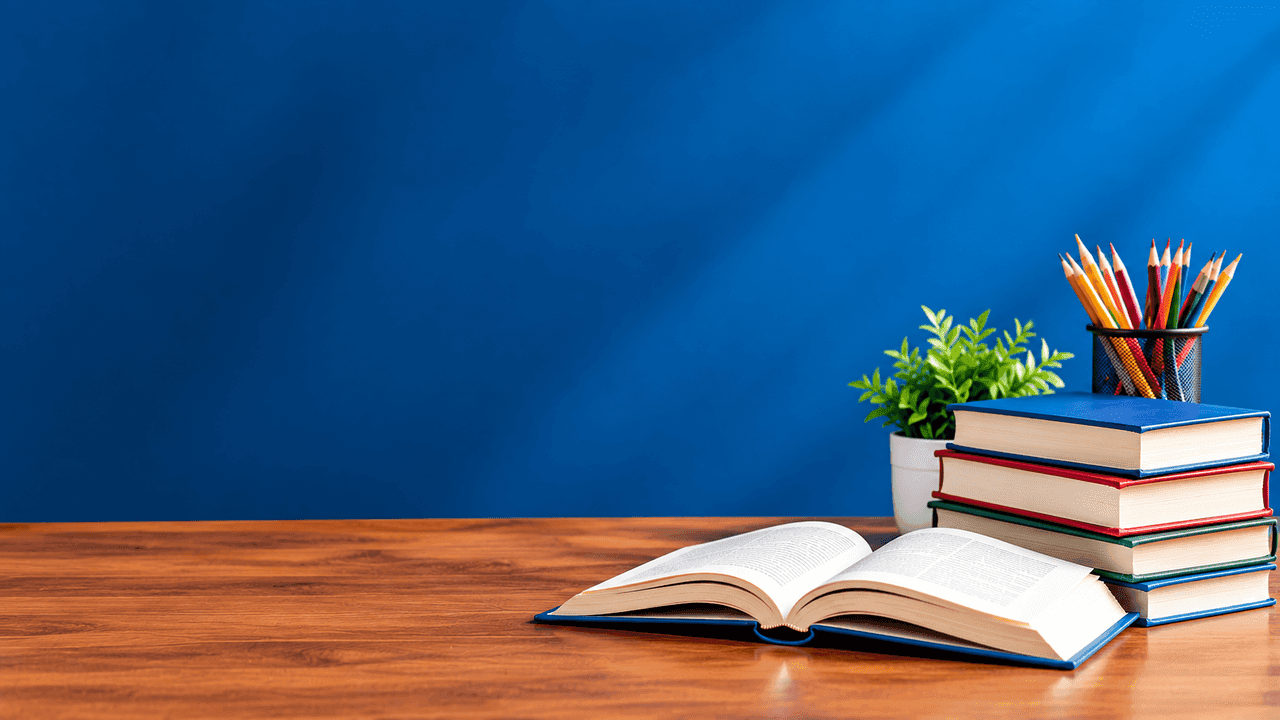 An open book, a stack of books and a pot of pencils on a desk