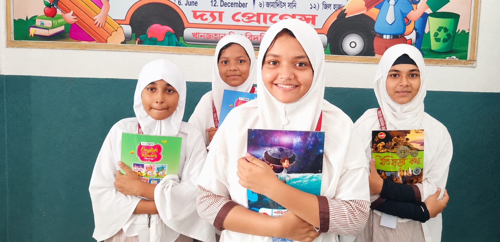 Four students of The Progress Academy holding their textbooks