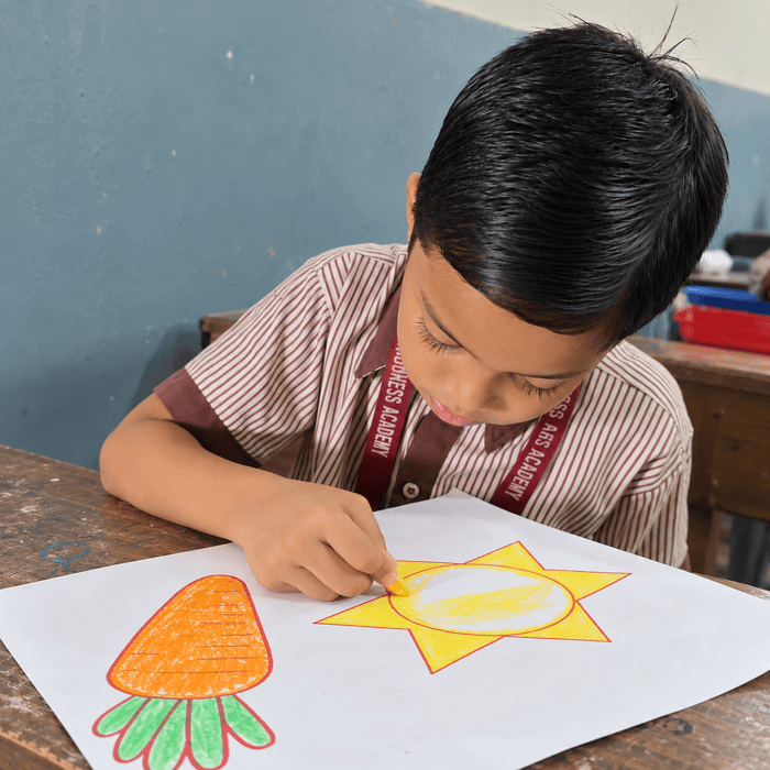 A student colouring a drawing at his desk